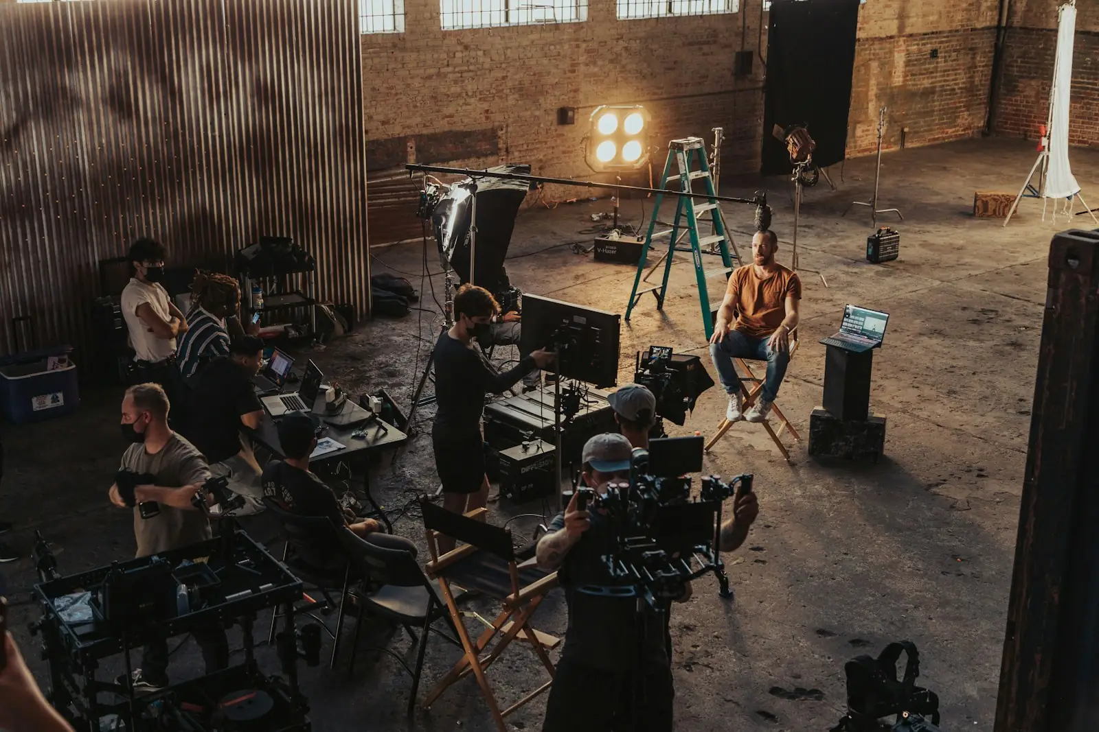 A group of people standing around a camera set-up, representing beauty brands producing entertainment-style content.