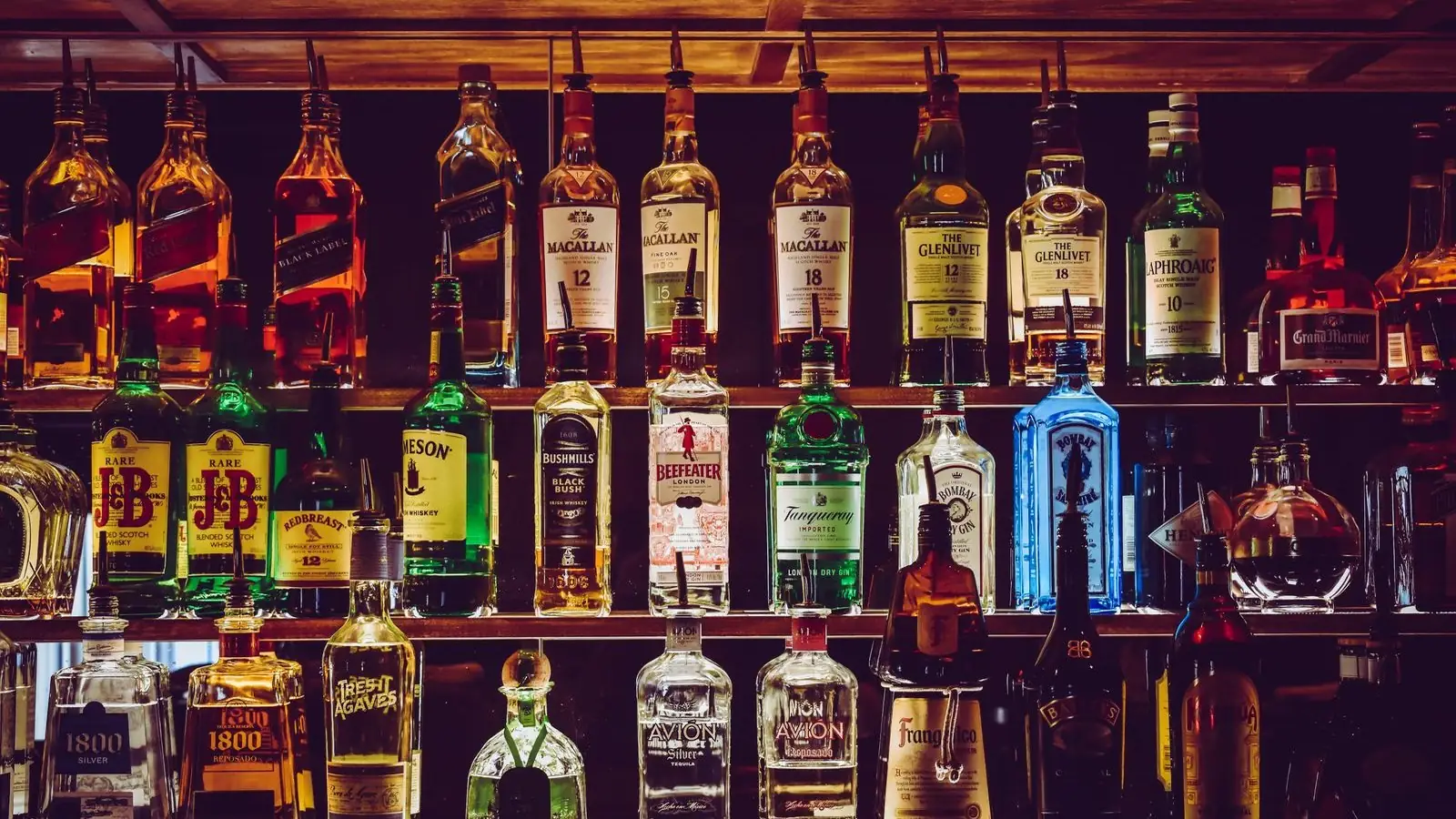 Whiskey bottle and glass representing Jack Daniel's branding, label design, and how bottle shape builds shelf recognition.